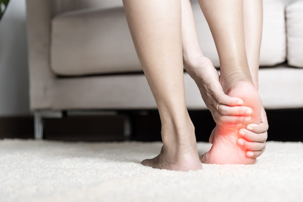 A woman suffers from heel pain.