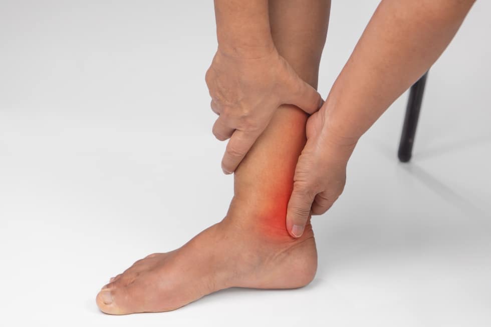A woman suffers from heel pain.